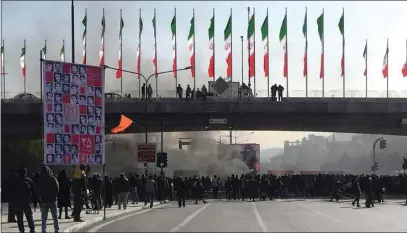  ?? THE ASSOCIATED PRESS ?? Smoke rises during a protest Saturday after authoritie­s raised gasoline prices in Isfahan, Iran.