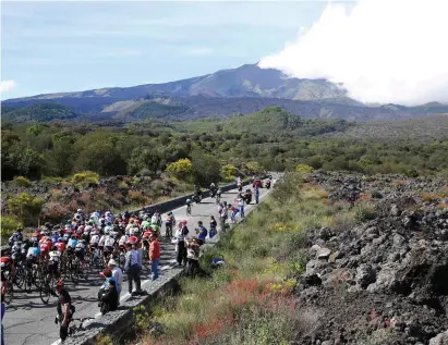  ??  ?? Riders climb towards the volcano of Mount Etna during yesterday’s Giro d’Italia stage from Cefalu to Etna in Sicily