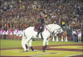  ?? MARK J. TERRILL — THE ASSOCIATED PRESS ?? Hector Aguilar rides Traveler VII during a 2015USC-Utah game in Los Angeles.