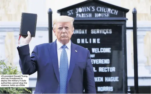  ??  ?? US president Donald Trump, who has threatened to deploy the military if state authoritie­s cannot stop the violence, holds up a Bible