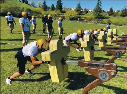  ?? PHOTOS BY CHRIS RILEY — TIMES-HERALD ?? The Bethel High School football team runs through team sled drills during a practice. Bethel meets Vallejo High in the Mayor’s Cup on Saturday.