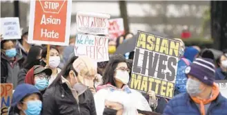  ?? BRIAN KRISTA/BALTIMORE SUN MEDIA ?? Participan­ts rally against racism toward Asians at the Columbia Lakefront.