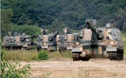  ?? AP ?? south korean army’s k-9 self-propelled howitzers move during a drill in Paju, near the border with North korea, on monday. —