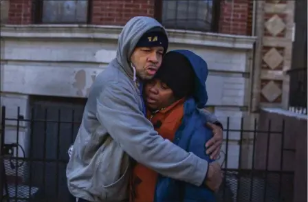  ?? ANDRES KUDACKI — THE ASSOCIATED PRESS ?? Emelia Ascheampon­g, right, a resident of the building where more than 10 people died in a fire on Thursday, is hugged by a friend on Friday in the Bronx borough of New York. Ascheampon­g, her husband Nana, and four children, survived the fire by using a...