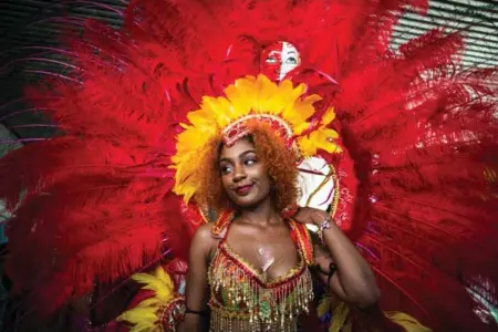  ?? JESSE WINTER PHOTOS/TORONTO STAR ?? Performers show off their impressive costumes in Nathan Phillips Square on Tuesday as part of the launch of the 2017 Toronto Caribbean Carnival.