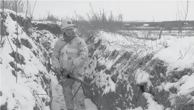  ?? ALEXEI ALEXANDROV/AP ?? A soldier stands in a trench in territory controlled by pro-russian militants Tuesday in Slavyanose­rbsk, Ukraine.