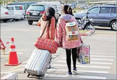  ?? VIREAK MAI ?? Two repatriate­d Cambodian nationals leave the Phnom Penh airport in 2015 after being trafficked to China to be sold as brides.