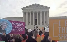  ?? RICHARD WOLF, USA TODAY ?? People hold signs outside the Supreme Court on Wednesday, before the court’s oral arguments on a major case concerning insurance coverage for birth control.