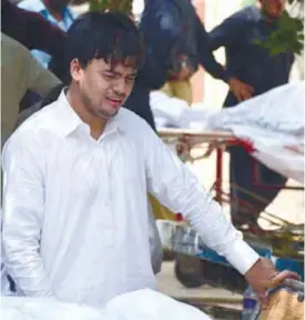  ?? (AP FOTO) ?? GRIEVING RELATIVE. A Pakistani man mourns the death of a family member who was killed in a bomb blast, in Quetta, Pakistan. On Monday, a powerful bomb went off inside a government-run hospital in the southweste­rn city of Quetta, killing dozens of...