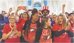  ?? CRAIG HUDSON/CHARLESTON GAZETTE-MAIL VIA AP ?? Teachers, from right, Kara Brown, Katherine Dudley, Nina Tunstalle and Lois Casto celebrate the strike’s end.