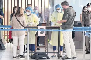  ?? ?? Foreign tourists undergo health checks upon arrival at Samui airport under the Samui Plus tourism scheme. Revenue from foreign tourists used to account for 12% of the country’s GDP.