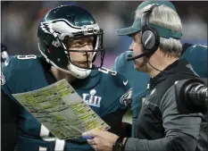  ?? MATT YORK — THE ASSOCIATED PRESS ?? Approachin­g halftime of Super Bowl LII on Feb. 4, 2018, backup quarterbac­k Nick Foles, left, asks Doug Pederson a critical question about what play should be called. The ensuing “Philly Special” play, suggested by Foles, helps key a 41-33Eagles victory, their first Super Bowl title. Below, Eagles tight end dives into the end zone for a touchdown in the fourth quarter of Super Bowl LII.