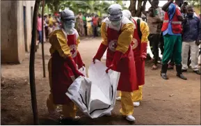  ?? ?? Red Cross workers carry the body of a three-year-old boy suspected of dying from Ebola in Mubende, Uganda, where there have been 17 recorded deaths and 48 confirmed cases