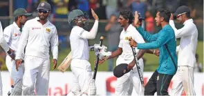  ?? – AFP ?? CELEBRATIO­NS : Bangladesh players celebrate after their victory over Sri Lanka on the final day of their second and final Test match against Sri Lanka at the P. Sara Oval in Colombo on Sunday.