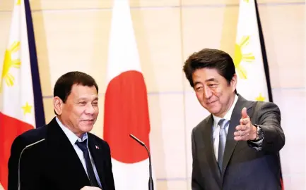  ??  ?? Philippine President Rodrigo Duterte, left, is shown the way by Japanese Prime Minister Shinzo Abe after a joint press conference following their meeting at Abe’s official residence in Tokyo, on Wednesday. (AP)