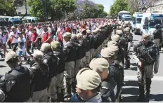  ?? AFP ?? Security forces stand guard as River Plate’s supporters leave the Monumental stadium in Buenos Aires on Sunday.