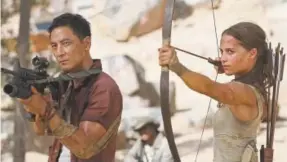  ?? Ilze Kitshoff, Warner Bros. Pictures ?? Daniel Wu, left, and Alicia Vikander in “Tomb Raider.”