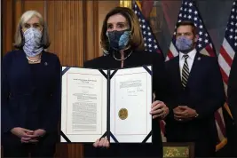  ?? ALEX BRANDON — THE ASSOCIATED PRESS ?? House Speaker Nancy Pelosi, D-Calif., displays the signed article of impeachmen­t against President Donald Trump in Washington on Wednesday.