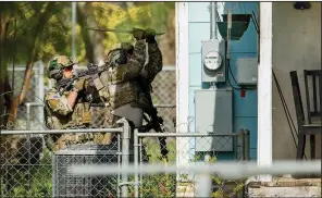  ?? Austin American-Statesman/JAY JANNER ?? FBI agents break out the windows of Mark Anthony Conditt’s home in Pflugervil­le, Texas, on Wednesday. Homemade explosives were removed from the house and Conditt’s two roommates were detained for questionin­g. One was released later.