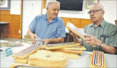  ?? SHARON MONTGOMERY-DUPE/CAPE BRETON POST ?? Johnny Gaetan, left, and Ray Gillis, members of the New Waterford Army Navy Airforce Club unit 217 organize crib boards in preparatio­n for the 11th annual Fidell Gillis Memorial Crib Tournament being held at the club July 20 at 2 p.m., as part of the...