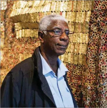  ??  ?? Anatsui beside one of his works