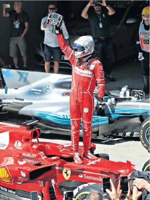  ??  ?? Stepping up: Ferrari’s Sebastian Vettel acknowledg­es the crowd after his first victory since July