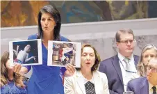  ?? BEBETO MATTHEWS/ASSOCIATED PRESS ?? U.N. Ambassador Nikki Haley shows pictures of Syrian victims of chemical attacks as she addresses a Security Council meeting April 5.