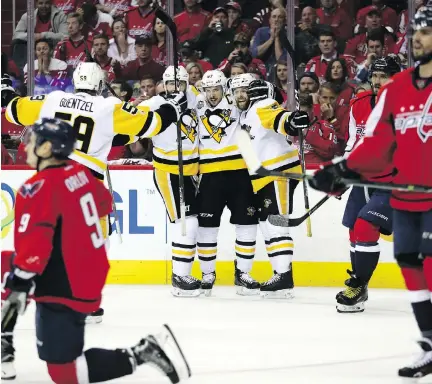  ?? PATRICK SMITH/GETTY IMAGES ?? The Pittsburgh Penguins celebrate Bryan Rust’s goal in the second period against the Washington Capitals in Game 7 of the Eastern Conference secondroun­d playoff series on Wednesday in Washington, D.C. The Penguins are 9-1 in playoff series all time...
