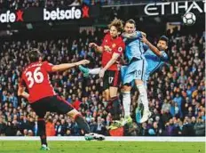  ?? Reuters ?? Manchester City’s Sergio Aguero and Nicolas Otamendi in action with Manchester United’s Daley Blind in the Premier League match at Etihad Stadium on Thursday.