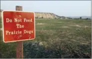  ?? BETH J. HARPAZ — THE ASSOCIATED PRESS ?? This Sept. 3 photo shows a “Do not feed the prairie dogs” sign at Theodore Roosevelt National Park in Medora, N.D., with a view of the badlands in the background.