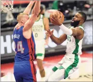  ?? Jose Juarez / Associated Press ?? Boston Celtics guard Jaylen Brown, right, drives against Detroit Pistons center Mason Plumlee during the first half Sunday in Detroit. Brown led the Celtics with 31 points