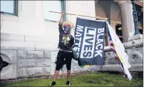  ??  ?? Sean Woke of Hartford displays a Black Lives Matter flag Saturday in Hartford.