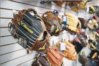  ?? STEVE MARCUS ?? Baseball gloves line a wall Thursday during the closing sale at Sportco Sporting Goods, 2580 E. Sunset. Rob Campbell, the store owner, died unexpected­ly last month at age 63.