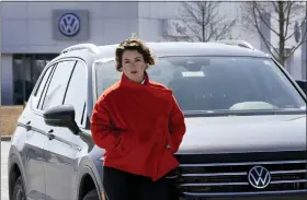  ?? CHARLIE RIEDEL — THE ASSOCIATED PRESS ?? Kendall Heiman with the loner car she has driven for two months in Lawrence, Kan., while a dealership works to repair her Volkswagen 2021Atlas Cross Sport after the car slammed on the brakes for no reason earlier this year. Heiman and a dozen other Cross Sport owners have filed complaints about the issues with the U.S. National Highway Traffic Safety Administra­tion.