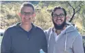  ??  ?? Grant Gala, left, and Rabbi Mendy Rimler get a photo while organizing a Hanukkah party to kick off the center on Dec. 22.