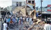  ??  ?? A crowd gathers at the site of an explosion in Petlawad, in the central Indian state of Madhya Pradesh, Saturday, Sept. 12, 2015. Dozens of people were killed at a restaurant in central India on Saturday when a cooking gas cylinder exploded and...