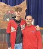  ?? ADAM JARDY/COLUMBUS DISPATCH ?? Kalen Etzler, left, and his coach and uncle Doug Etzler pose for a photo after Kalen announced his decision to attend Ohio State in November 2020.