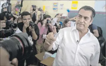  ?? Hans Maximo Musielik
Associated Press ?? JAIME ‘EL BRONCO’ RODRIGUEZ shows his inked finger after voting in Nuevo Leon state, where he won the governorsh­ip. He is the first independen­t elected to a major office in modern Mexican history.