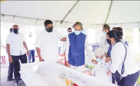  ?? ?? President Irfaan Ali (second from left) paid final respects to Persaud yesterday morning at his Nandy Park, EBD residence. (Office of the President photo)