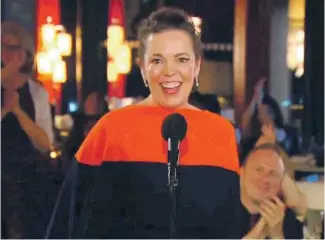  ?? AP ?? OLIVIA COLMAN, in London, accepts her Emmy for lead actress in a drama series, for portraying Queen Elizabeth II in “The Crown.”