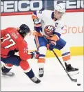  ?? Nick Wass / Associated Press ?? New York Islanders left wing Anders Lee (27) skates with the puck against Washington Capitals right wing T.J. Oshie during the first period on Thursday.