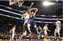  ?? AP-Yonhap ?? Los Angeles Lakers’ LeBron James, top left, defends as Denver Nuggets’ Aaron Gordon shoots during Game 4 of an NBA first-round playoff series in Los Angeles, Calif., Saturday.