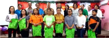  ??  ?? Recipients of the love gifts in a photocall with (from fourth left – back row) Andrew and his wife Nelly Unyang and other church leaders.