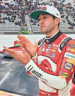  ?? STEVE HELBER/AP ?? Chase Elliott celebrates winning the pole for Saturday's NASCAR Cup Series race at Martinsvil­le Speedway.