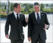  ?? DMITRY ASTAKHOV, SPUTNIK, GOVERNMENT POOL PHOTO VIA AP ?? Russian Prime Minister Dmitry Medvedev, left, and Turkmenist­an’s President Gurbanguly Berdymukha­medov speak Monday in Turkmenbas­hi, Turkmenist­an.