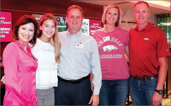  ?? NWA Democrat-Gazette/CARIN SCHOPPMEYE­R ?? Stephanie Horne (from left), Caroline Horne, Greg Horne and Kim Storey Chronister and Graham Chronister gather Sept. 13 at the University of Arkansas Sports Hall of Honor reception at Donald W. Reynolds Razorback Stadium in Fayettevil­le.