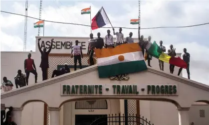  ?? Photograph: Reuters ?? Men hold Nigerien and Russian flags as they rally in support of the putschist soldiers in the capital, Niamey.