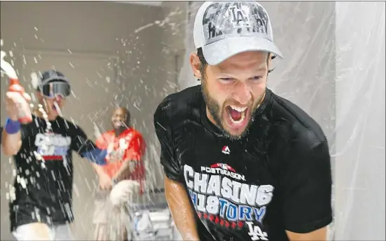  ?? Wally Skalij Los Angeles Times ?? PITCHER Clayton Kershaw participat­es in the postgame champagne celebratio­n after the visiting Dodgers eliminated Atlanta in the National League Division Series.