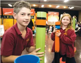  ??  ?? Drouin West Primary School students Keenan Shanks and Shelby Walker make music with the varied pipes using suction.