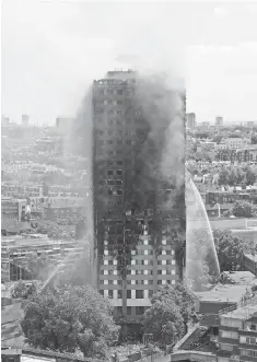  ?? ADRIAN DENNIS, AFP/ GETTY IMAGES ?? Smoke and flames billow from Grenfell Tower as firefighte­rs try to control a blaze at a residentia­l block of flats on early Wednesday morning in west London. At least 17 people are dead and many others injured and missing.